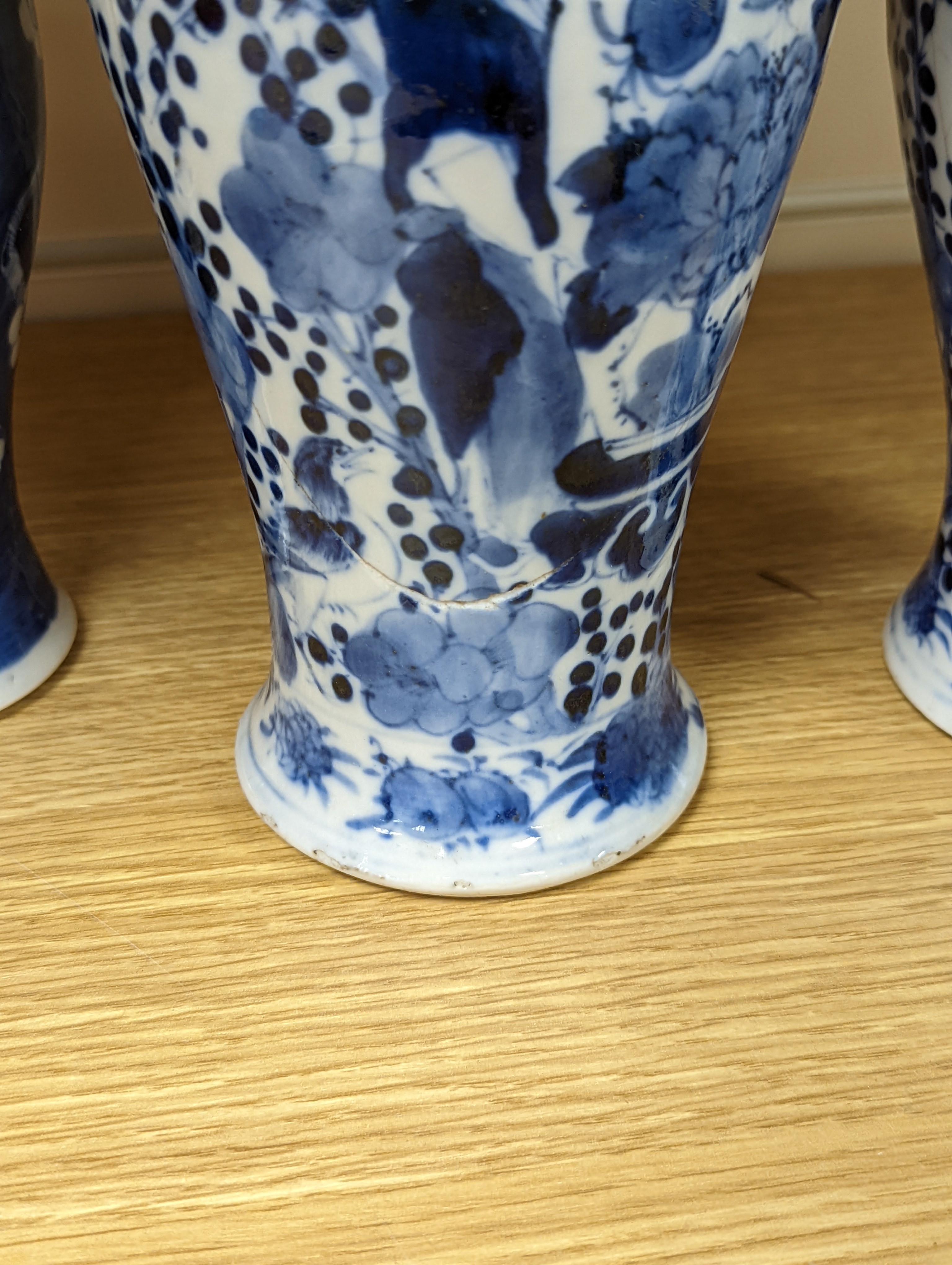 A pair of 19th century Chinese blue and white vases, a prunus vase and cover and a similar jar (4), pair of vases 24 cms high.